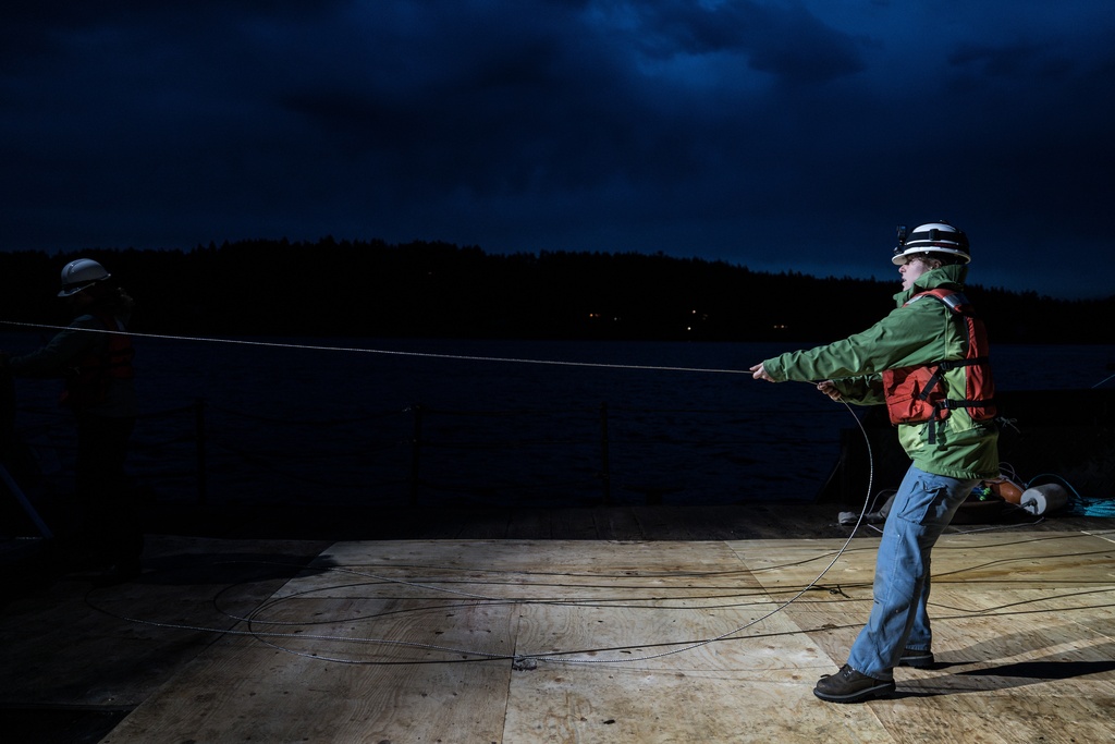 Isabelle Brandicourt, a graduate student at the University of Washington School of Oceanography, prepares to deploy a 1.3-mile fiber-optic cable to test whether internet cables can detect endangered orca vocalizations near San Juan Island, Wash., Friday, Oct. 10, 2025. (AP Photo/Annika Hammerschlag)