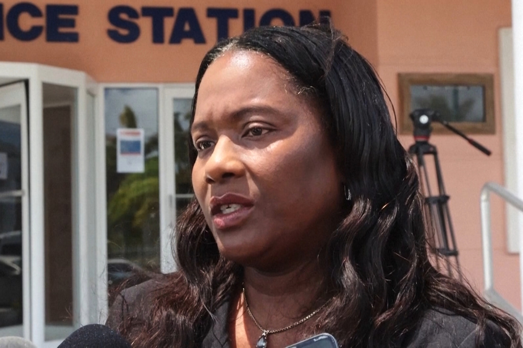 In this image, taken from an Associated Press video, Terrel Butler, the attorney representing Brian Hooker, talks to reporters Friday, April 10, 2026, outside the police station in Freeport, Bahamas. (AP Photo/Keith Gomez)