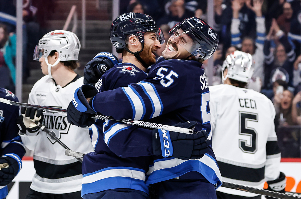 Winnipeg Jets' Mark Scheifele (55) and Gabriel Vilardi, center left, celebrate after Scheifele's goal against the Los Angeles Kings during second-period NHL hockey game action in Winnipeg, Manitoba, Friday, Jan. 9, 2026. (John Woods/The Canadian Press via AP)
