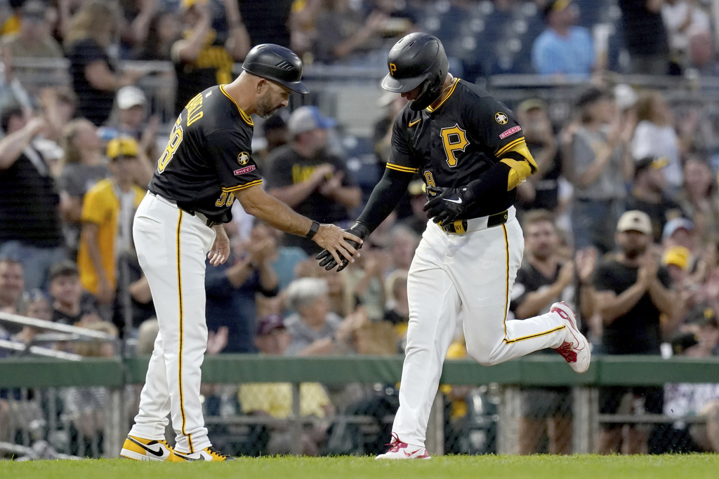 Pittsburgh Pirates' Nick Yorke, right, is greeted by third base coach Mike Rabelo, left, as he rounds the bases after hitting a home run during the second inning of a baseball game against the Athletics, Saturday, Sept. 20, 2025, in Pittsburgh. (AP Photo/Matt Freed)