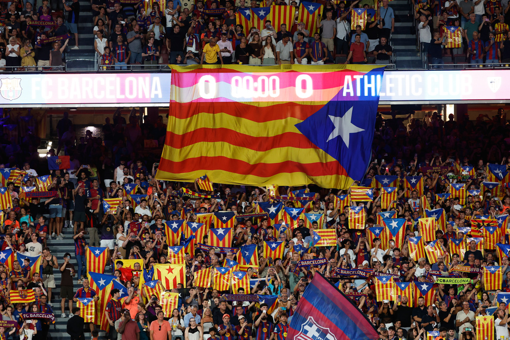 Supporters lift independence flags during a Spanish La Liga soccer match between Barcelona and Athletic in Barcelona, Spain, Thursday, Aug. 27, 2026. (AP Photo/Joan Monfort)