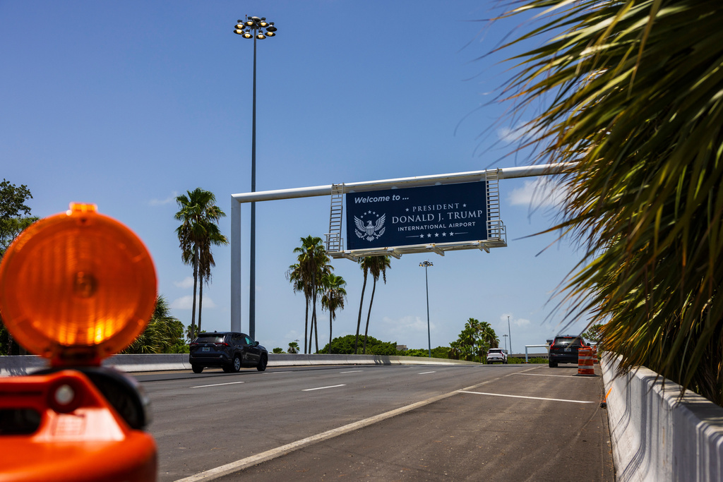 Airport visitors drive under a sign displaying the name of the rebranded Donald J. Trump International Airport in West Palm Beach, Fla., Thursday, July 9, 2026. (AP Photo/Saul Martinez)