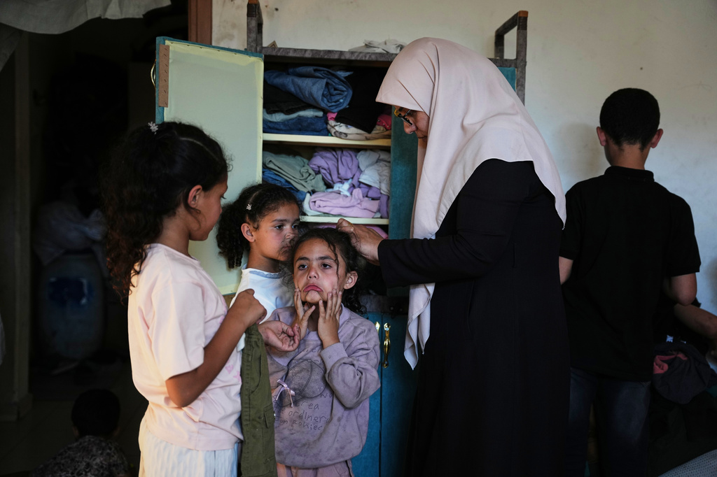 Ikhlas al-Kafarna, 35, cares for her orphaned nieces and nephews at her home in Gaza City, May 31, 2026. The children lost their parents in an Israeli airstrike. (AP Photo/Abdel Kareem Hana)