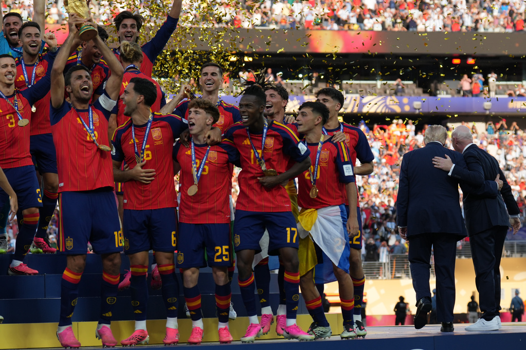Spain players, from left, cheer alongside President Donald Trump and FIFA President Gianni Infantino at the conclusion of the World Cup championship final soccer match between Spain and Argentina in East Rutherford, N.J., Sunday, July 19, 2026. (AP Photo/Jacquelyn Martin)