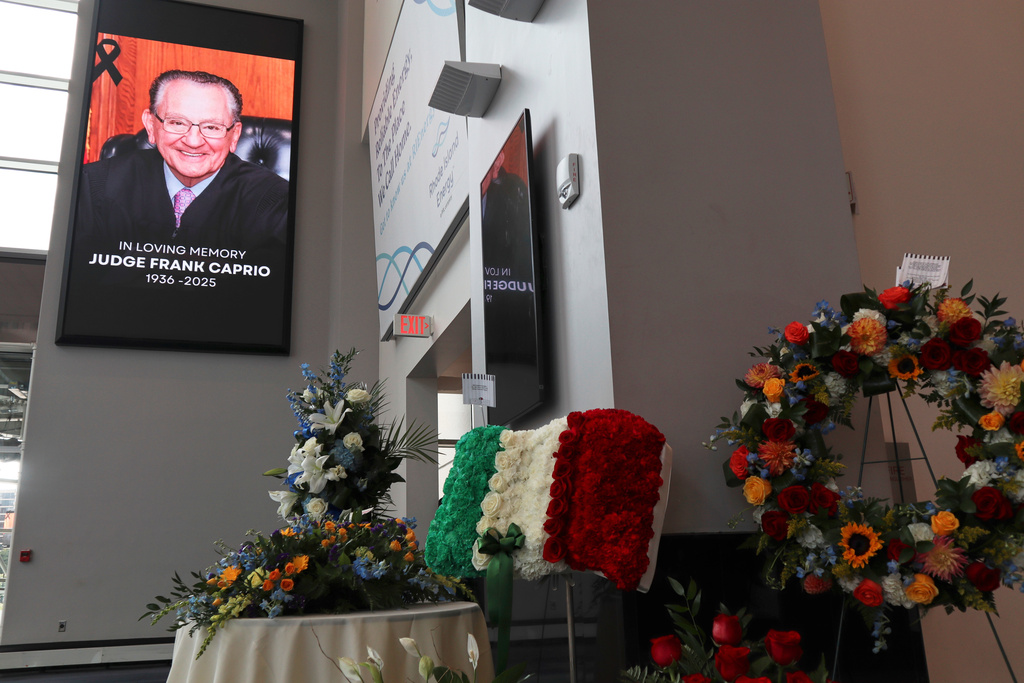 Flowers are displayed at the visiting hours for former Judge Frank Caprio at the Rhode Island Convention Center in Providence, R.I. on Thursday, Aug. 28, 2025. (AP Photo/Leah Willingham)
