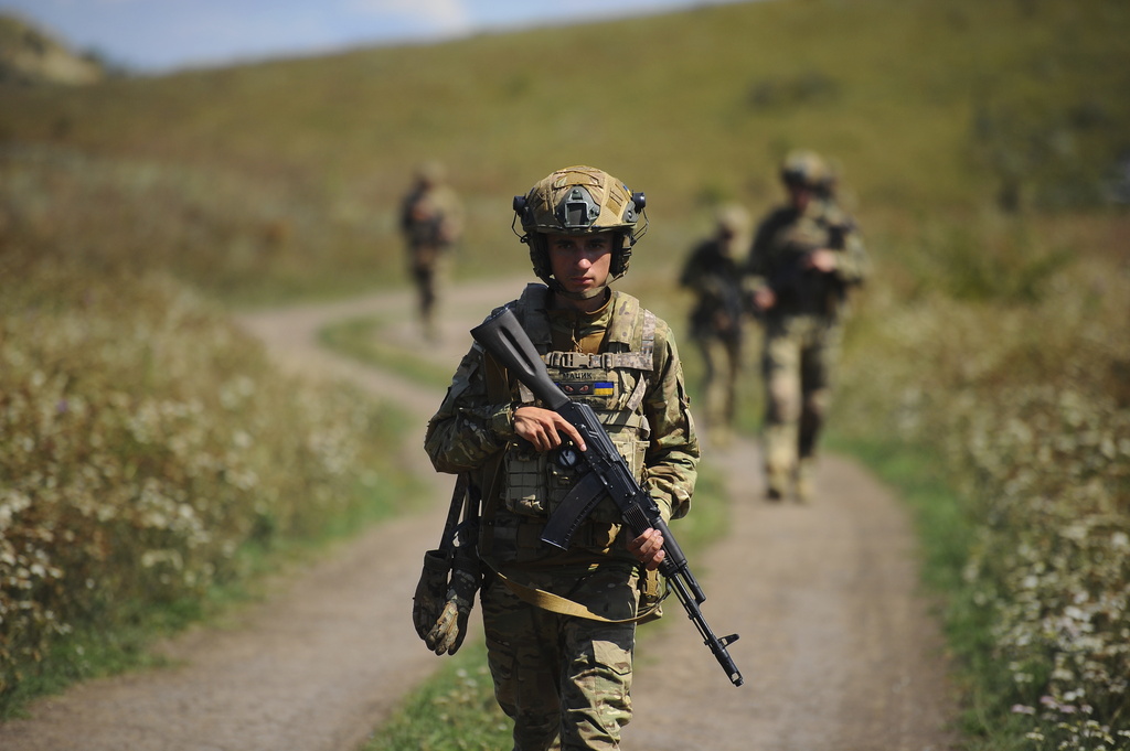 In this photo, taken on Tuesday, Aug. 19, 2025 and provided by Ukraine's 127th Separate Brigade of the Territorial Defence press service, soldiers aged 18 to 24 practice military skills on a training ground near Kharkiv, Ukraine. (Anatolii Lysianskyi/Ukraine's 127th Separate Brigade via AP)