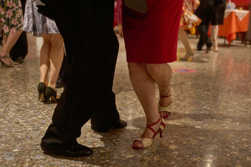 Women dance with professional tango dancers at the Che Che Tango Premium, where people can book guaranteed two‑hour dances with professional partners known as “Taxi Dancers," in Buenos Aires, Wednesday, Dec. 3, 2025. (AP Photo/Victor R. Caivano)