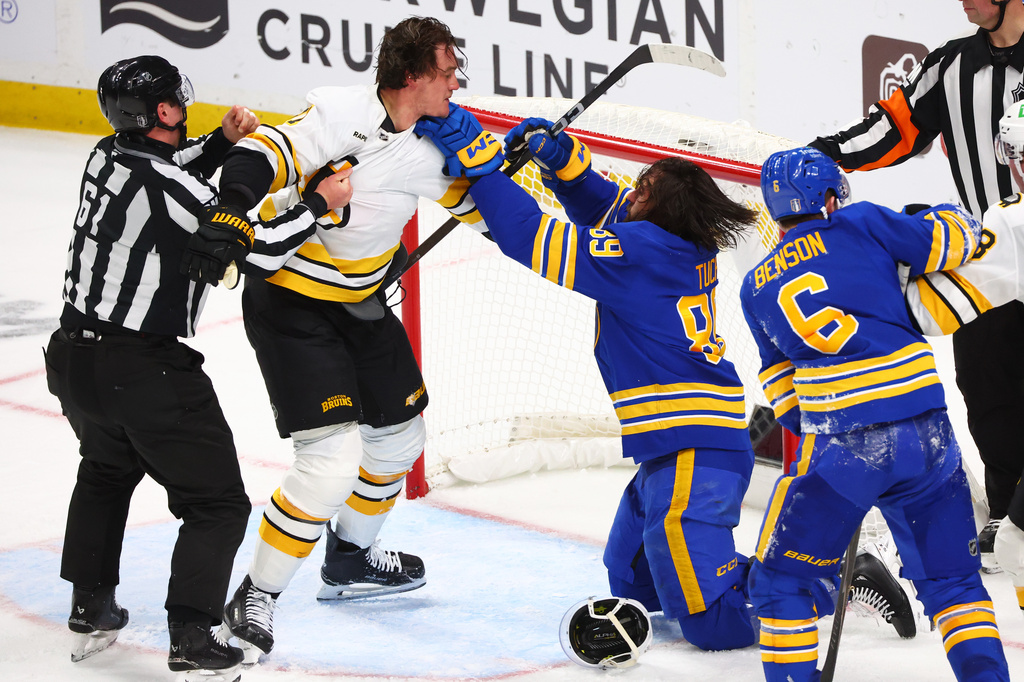 Boston Bruins defenseman Nikita Zadorov (91) and Buffalo Sabres right wing Alex Tuch (89) fight during the third period in Game 2 of a first-round NHL hockey Stanley Cup playoff series Tuesday, April 21, 2026, in Buffalo, N.Y. (AP Photo/Jeffrey T. Barnes)