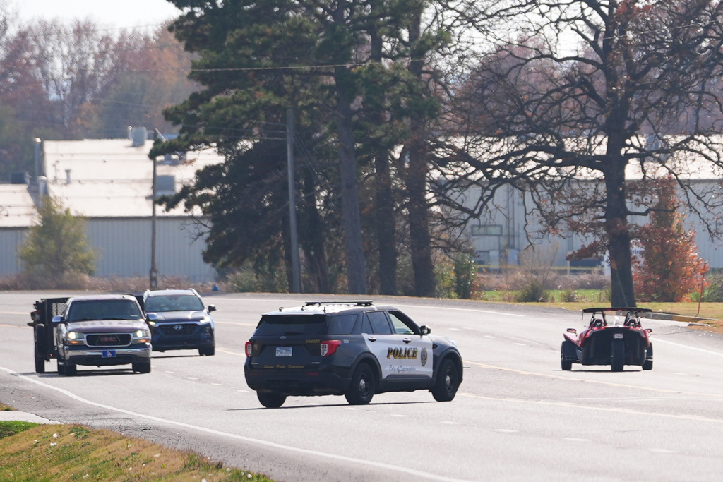 A Springdale, Ark., police vehicle, center, pulls over a convertible vehicle, right, Nov. 18, 2025, in Springdale, Ark. (AP Photo/Julio Cortez)
