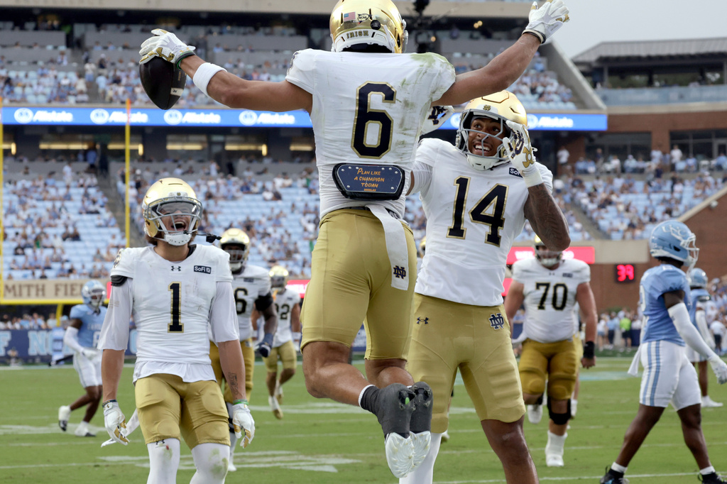 Notre Dame wide receiver Jordan Faison (6) celebrates his touchdown with wide receiver Jaden Greathouse (1) and wide receiver Micah Gilbert (14) during the first half of an NCAA college football game against North Carolina, Saturday, Oct. 3, 2026, in Chapel Hill, N.C. (AP Photo/Chris Seward)