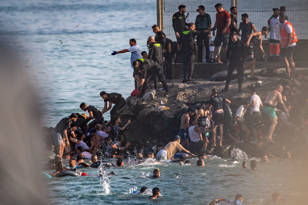FILE - Migrants try to cross from Morocco into the Spanish enclave of Ceuta, July 30, 2026. (AP Photo/Antonio Sempere, File)