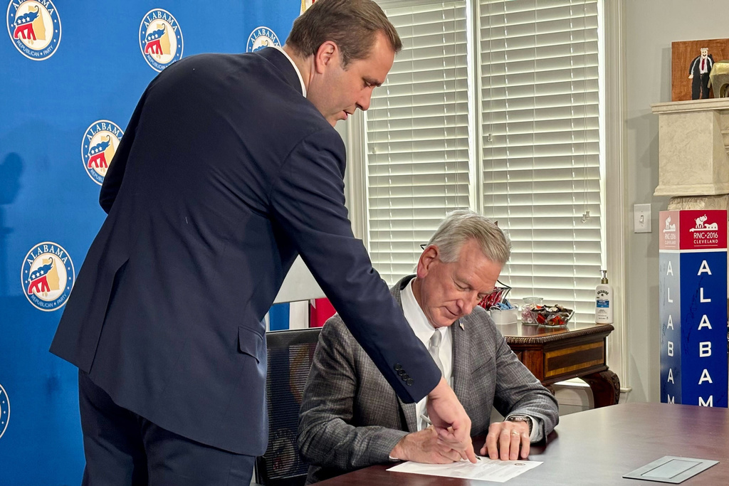 U.S. Sen. Tommy Tuberville, R-Ala., signs paperwork to run for governor Monday, Jan. 5, 2026, at the Alabama Republican Party headquarters in Hoover, Ala., as Alabama Republican Party Chairman John Wahl looks on. (AP Photo/Kimberly Chandler)