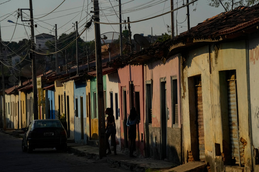 FILE - Residents walk along a sidewalk in Aracuai, Brazil, Oct. 11, 2022. (AP Photo/Andre Penner, File) FILE - Residents walk along a sidewalk in Aracuai, Brazil, Oct. 11, 2022. (AP Photo/Andre Penner, File)