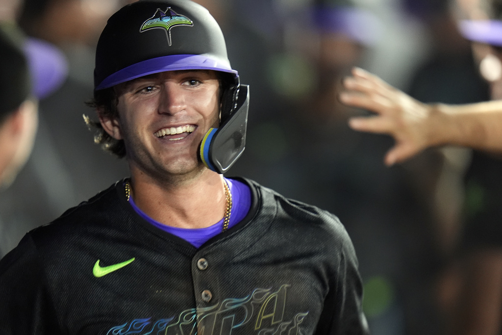 Tampa Bay Rays' Carson Williams celebrates in the dugout after his two-run home run off St. Louis Cardinals pitcher Ryan Fernandez during the seventh inning of a baseball game Friday, Aug. 22, 2025, in Tampa, Fla. (AP Photo/Chris O'Meara)
