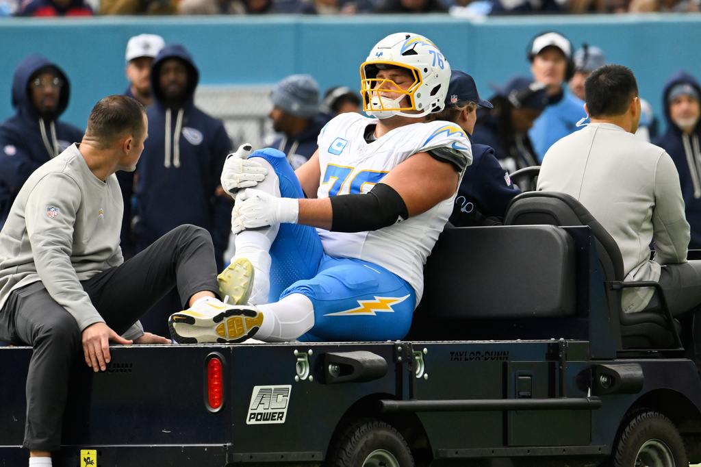 Los Angeles Chargers offensive tackle Joe Alt (76) is carted off the field during the first half of an NFL football game against the Tennessee Titans, Sunday, Nov. 2, 2025, in Nashville, Tenn. (AP Photo/John Amis)