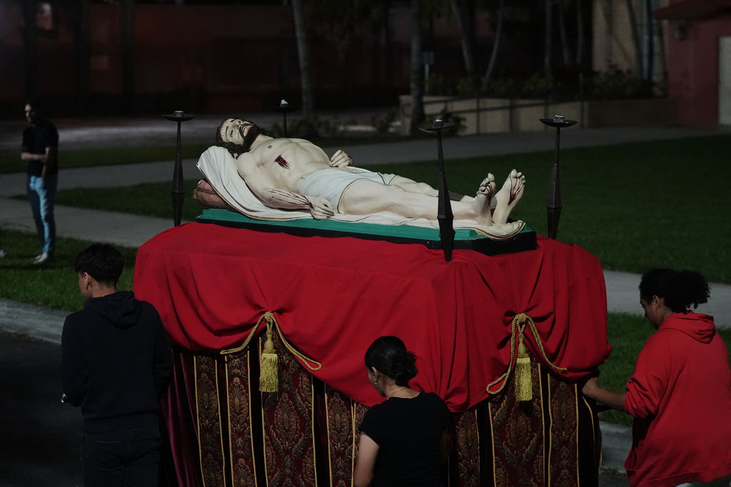 Corpus Christi Catholic Church youth group members push a float with Jesus during a rehearsal for their Good Friday procession Monday, March 23, 2026, in Miami, Fla. (AP Photo/Marta Lavandier)