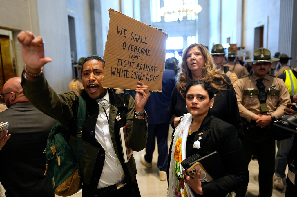 Rep. Justin Jones, D-Nashville, left, protests outside the House chamber with Rep. Gabby Salinas, D-Memphis, front right, and Gloria Johnson, D-Knoxville, behind, during a special session of the state legislature to redraw U.S. Congressional voting maps Thursday, May 7, 2026, in Nashville, Tenn. (AP Photo/George Walker IV)