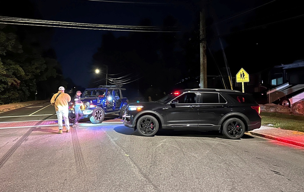FILE - Police block a road to the scene of a shooting at Sky Meadow Country Club in Nashua, N.H., Sept. 20, 2025. (AP Photo/Michael Casey)