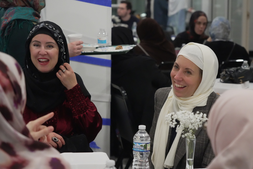 Rev. Sarah Trone Garriott, a Lutheran pastor and Iowa state senator, right, attends an Iftar dinner at the Es Selam Mosque in Granger, Iowa on Friday, March 13, 2026. (AP Photo/Krysta Fauria)