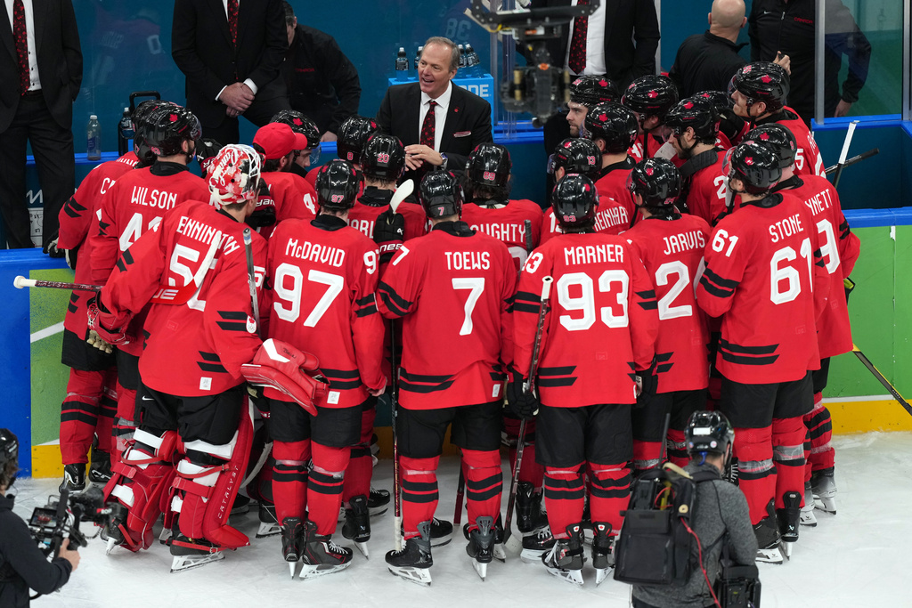 Canada head coach Jon Cooper talks with his players after their win against Finland in a men's ice hockey semifinal game at the 2026 Winter Olympics in Milan, Italy, Friday, Feb. 20, 2026. (AP Photo/Carolyn Kaster)