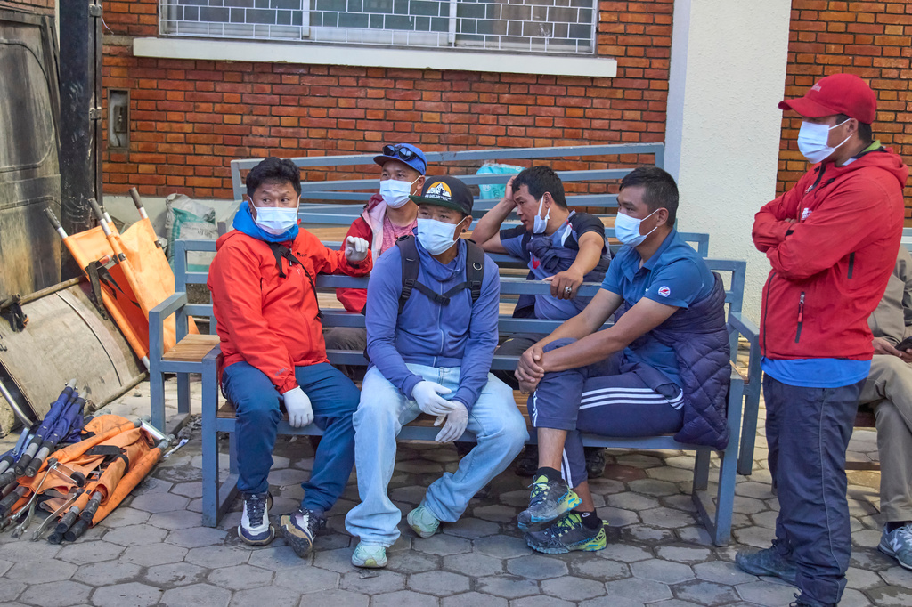 Family members and friends of Nepali climbers gather as the bodies of Nepali climbers recovered after an avalanche on Mount Himlung lie at the morgue of a hospital in Kathmandu, Nepal, Monday, Sept. 28, 2026. (AP Photo/Niranjan Shrestha)