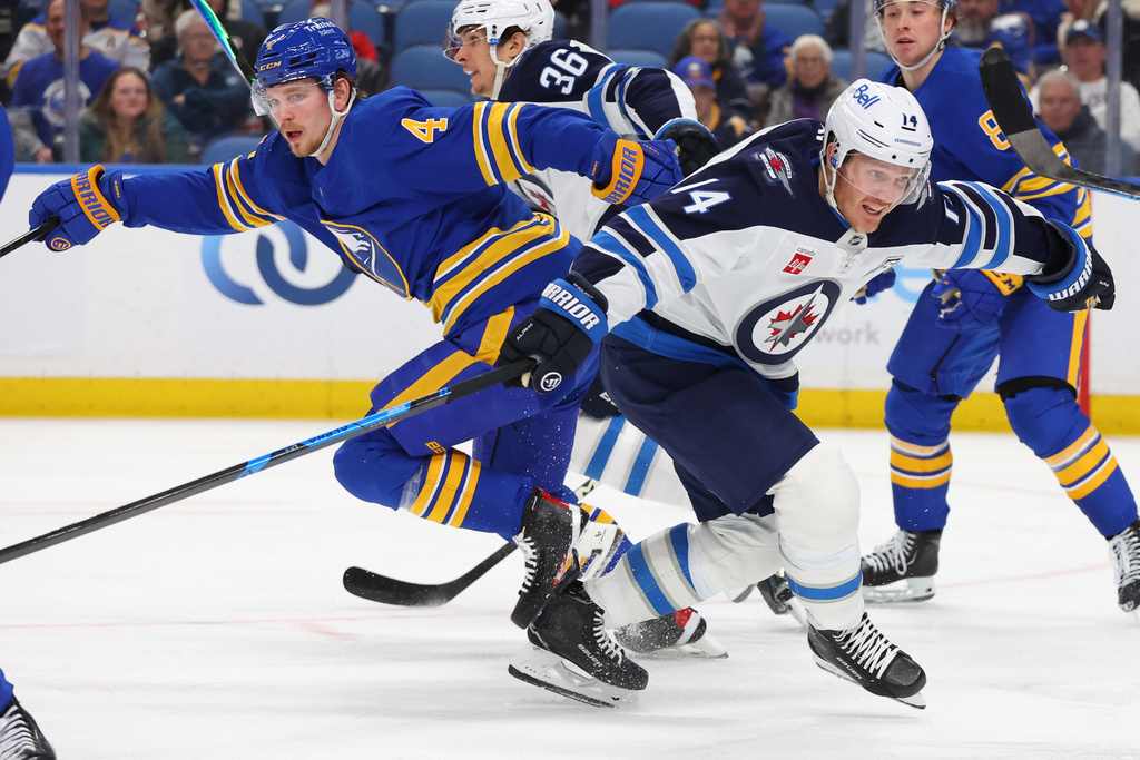 Buffalo Sabres defenseman Bowen Byram (4) and Winnipeg Jets right wing Gustav Nyquist (14) collide during the second period of an NHL hockey game Monday, Dec. 1, 2025, in Buffalo, N.Y. (AP Photo/Jeffrey T. Barnes)