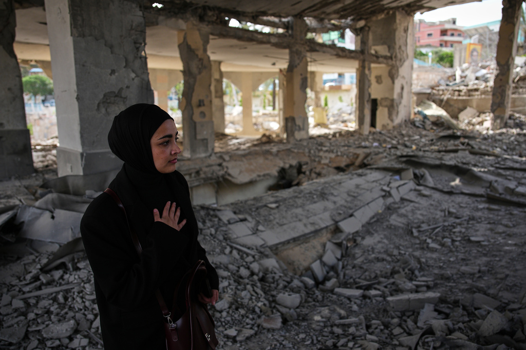 A locals resident walks among debris inside a mosque destroyed in an Israeli airstrike in Jibchit, southern Lebanon, Friday, April 17, 2026, following a ceasefire between Israel and Hezbollah. (AP Photo/Hassan Ammar)