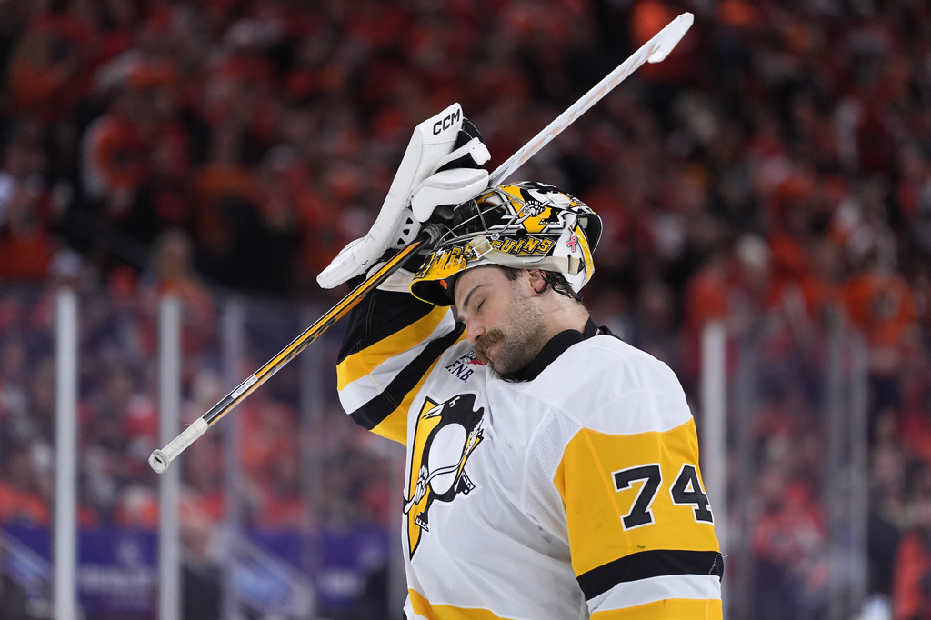 Pittsburgh Penguins' Stuart Skinner adjusts his mask during the second period of Game 3 against the Philadelphia Flyers in the first round of the NHL Stanley Cup hockey playoffs Wednesday, April 22, 2026, in Philadelphia. (AP Photo/Matt Slocum)