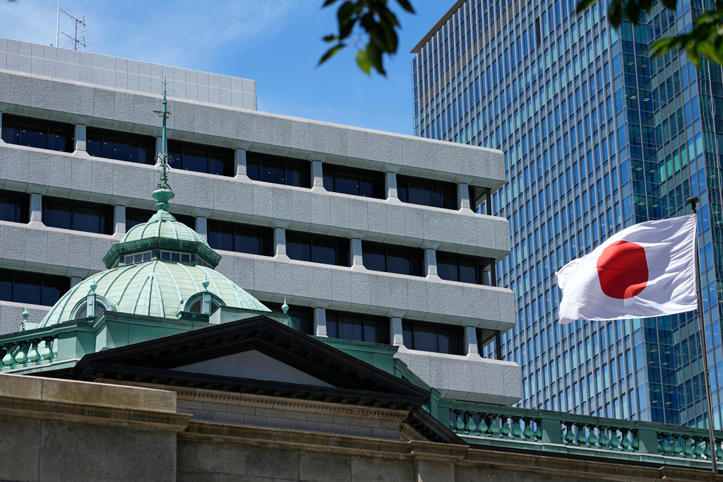 FILE - A Japanese flag flutters at the Bank of Japan headquarters in Tokyo, July 29, 2022. (AP Photo/Shuji Kajiyama, File)