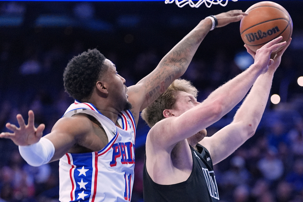 Brooklyn Nets' Danny Wolf, right, goes up to shoot against Philadelphia 76ers' Justin Edwards during the first half of an NBA basketball game Saturday, March 14, 2026, in Philadelphia. (AP Photo/Matt Rourke)