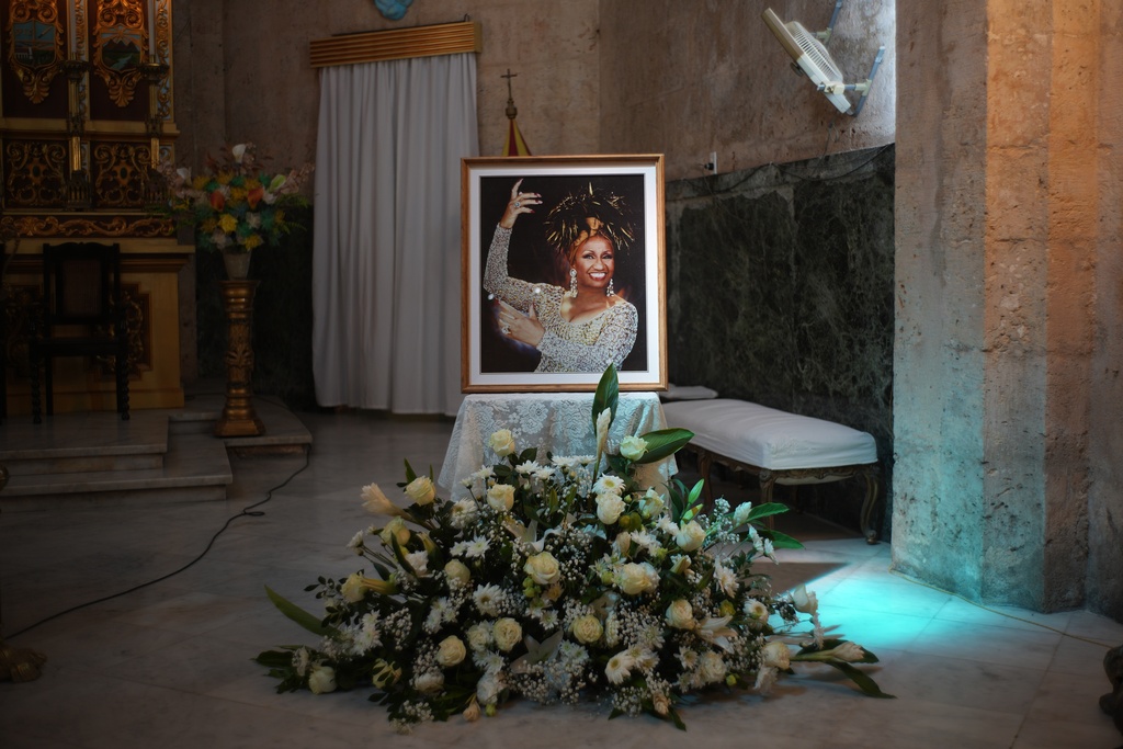 A framed image of late singer Celia Cruz is displayed in the Virgen del Cobre or Our Lady of Charity church where a memorial Mass was celebrated marking the centennial of her birth in Havana, Tuesday, Oct. 21, 2025. (AP Photo/Ramon Espinosa)