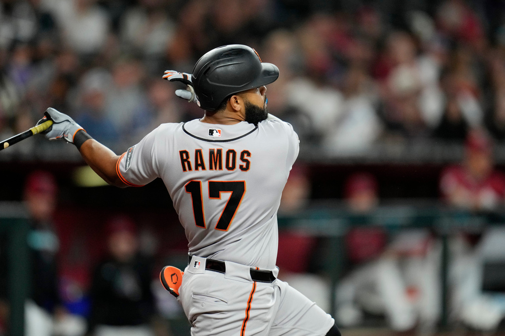 San Francisco Giants' Heliot Ramos watches the flight of his home run against the Arizona Diamondbacks during the fifth inning of a baseball game, Wednesday, July 1, 2026, in Phoenix. (AP Photo/Ross D. Franklin)
