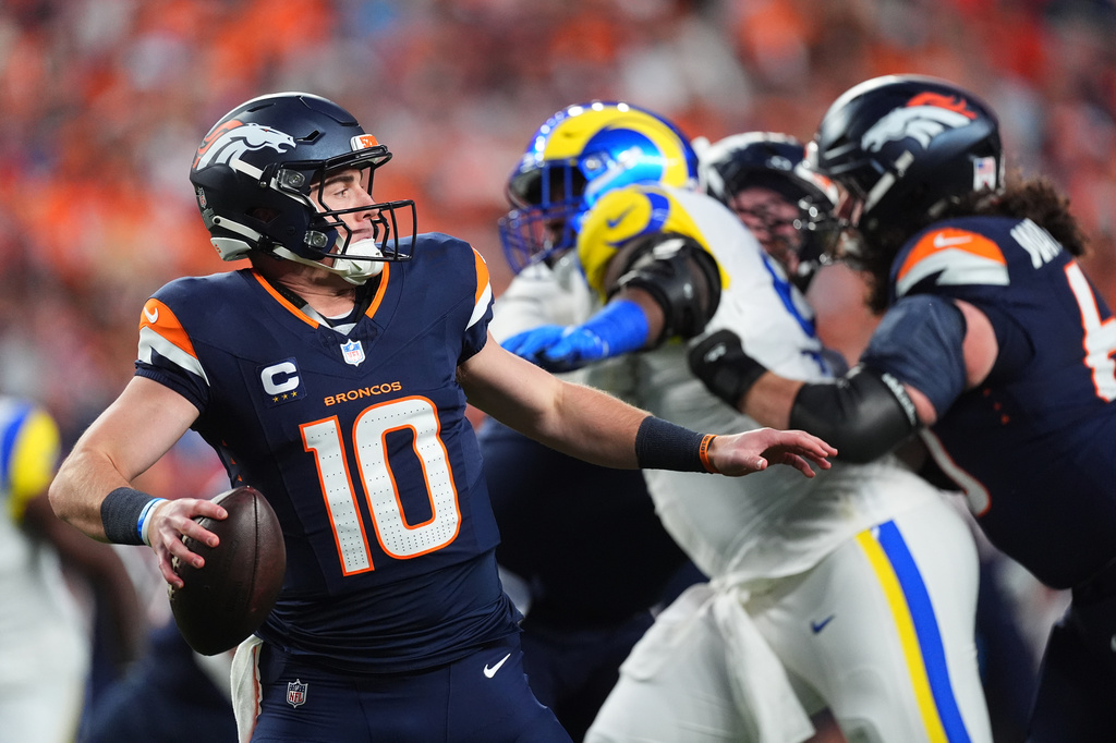 Denver Broncos quarterback Bo Nix looks to pass against the Los Angeles Rams during the first half of an NFL football game Sunday, Sept. 27, 2026, in Denver. (AP Photo/David Zalubowski)