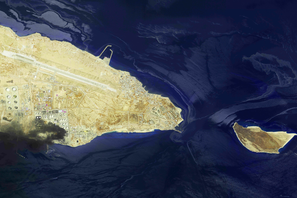 This image from an Airbus Defence and Space's Pléiades Neo satellite shows a fire at an oil refinery on Iran’s Lavan Island, left, and an oil slick in the waters of the Persian Gulf around Shidvar Island, right, April 10, 2026. (Airbus Defence and Space© via AP)