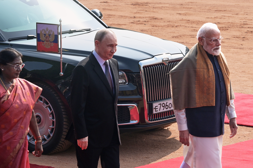 Russian President Vladimir Putin, center, walks along with Indian President Droupadi Murmu, left, and Indian Prime Minister Narendra Modi during a ceremonial reception at the Rashtrapati Bhavan in New Delhi, India, Friday, Dec. 5, 2025. (AP Photo)