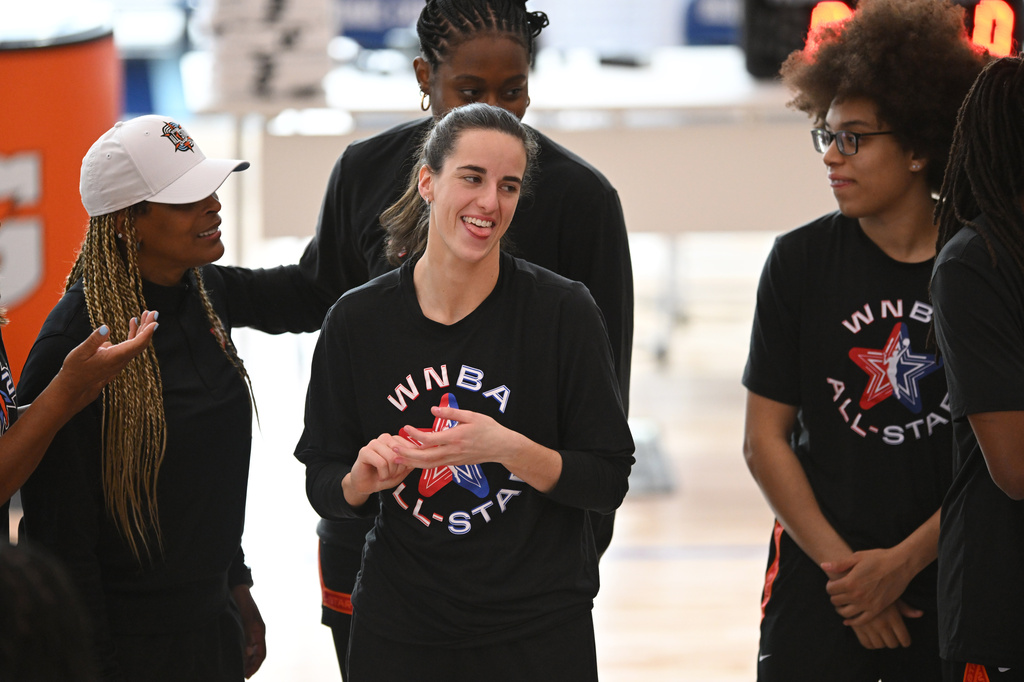 WNBA All-Star Caitlin Clark, center, reacts before practice at the Obama Presidential Center in Chicago, Friday, July 24, 2026. (AP Photo/Paul Beaty)