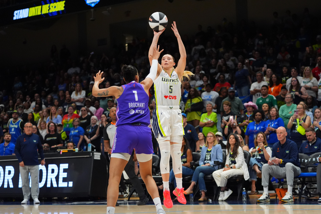 Dallas Wings guard Paige Bueckers (5) shoots against Phoenix Mercury forward Noemie Brochant (1) during the first half of a WNBA basketball game against the Phoenix Mercury in Arlington, Texas, Thursday, June 11, 2026. (AP Photo/LM Otero)