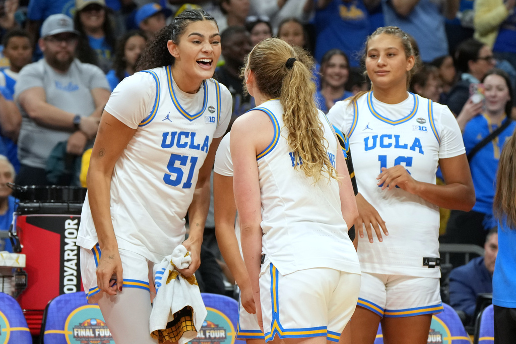 UCLA center Lauren Betts (51) celebrates with teammates during the second half of the women's National Championship Final Four NCAA college basketball tournament game against South Carolina, Sunday, April 5, 2026, in Phoenix. (AP Photo/Rick Scuteri)