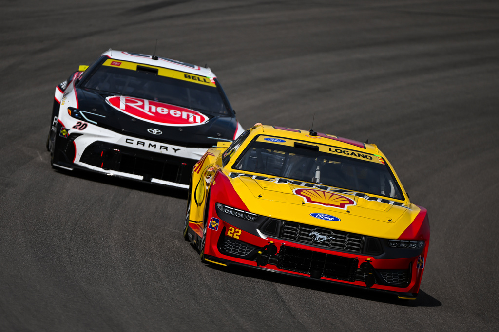 Christopher Bell (20) and Joey Logano (22) compete during a NASCAR Cup Series auto race Sunday, Sept. 13, 2026, in Madison, Ill. (AP Photo/Connor Hamilton)
