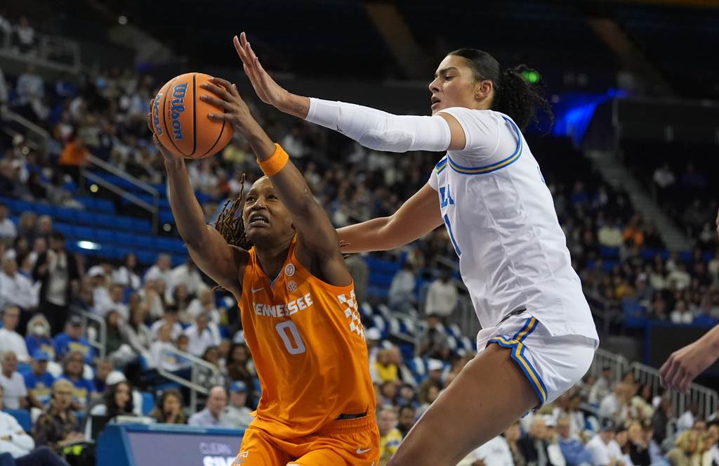 Tennessee forward Janiah Barker (0) grabs the ball defended by UCLA center Lauren Betts (51) during the first half of an NCAA college basketball game in Los Angeles, Sunday, Nov. 30, 2025. (AP Photo/Damian Dovarganes)