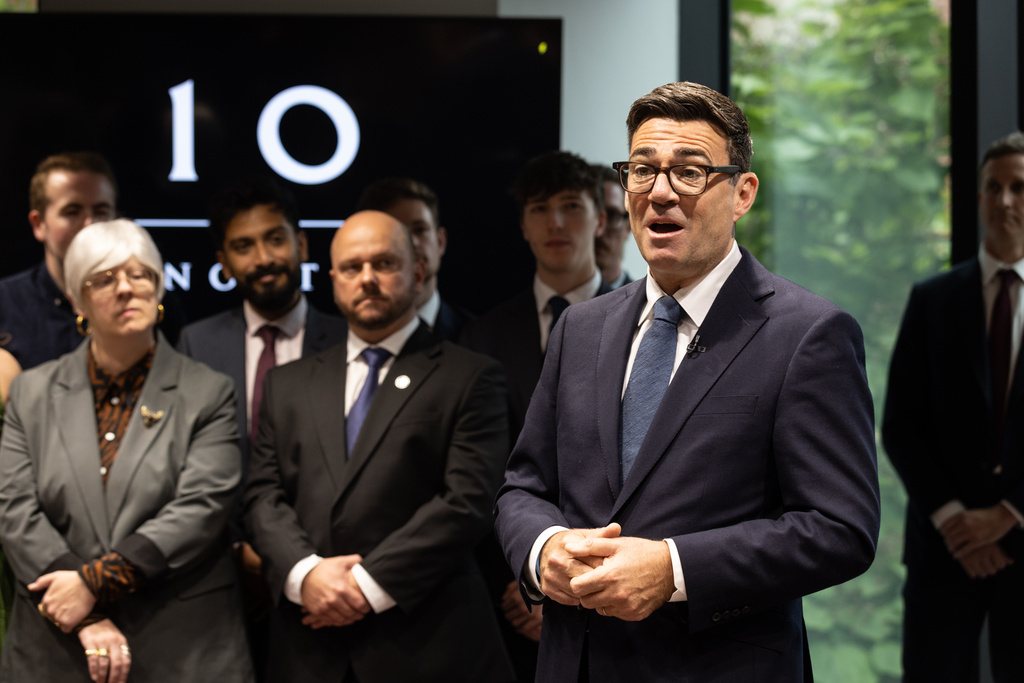 Britain's Prime Minister Andy Burnham arrives and greets staff at No 10 North, in Manchester, England, Friday, July 24, 2026. (James Speakman/Pool photo via AP)