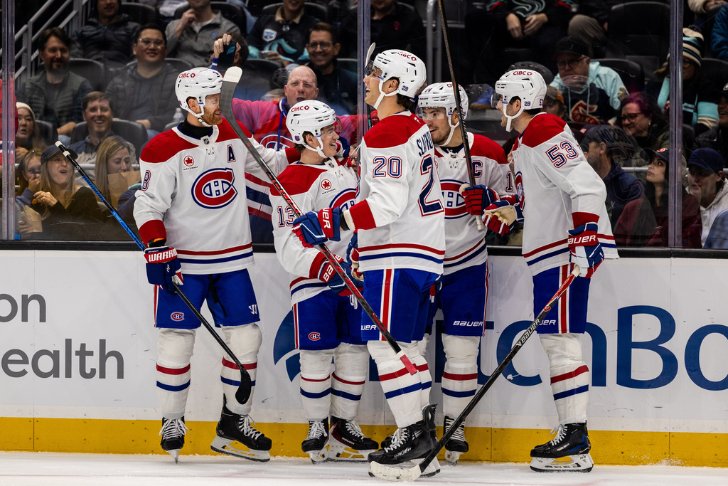 The Montreal Canadiens celebrate after a goal by right wing Cole Caufield during the first period of an NHL hockey game against the Seattle Kraken, Tuesday, Oct. 28, 2025, in Seattle. (AP Photo/Maddy Grassy)