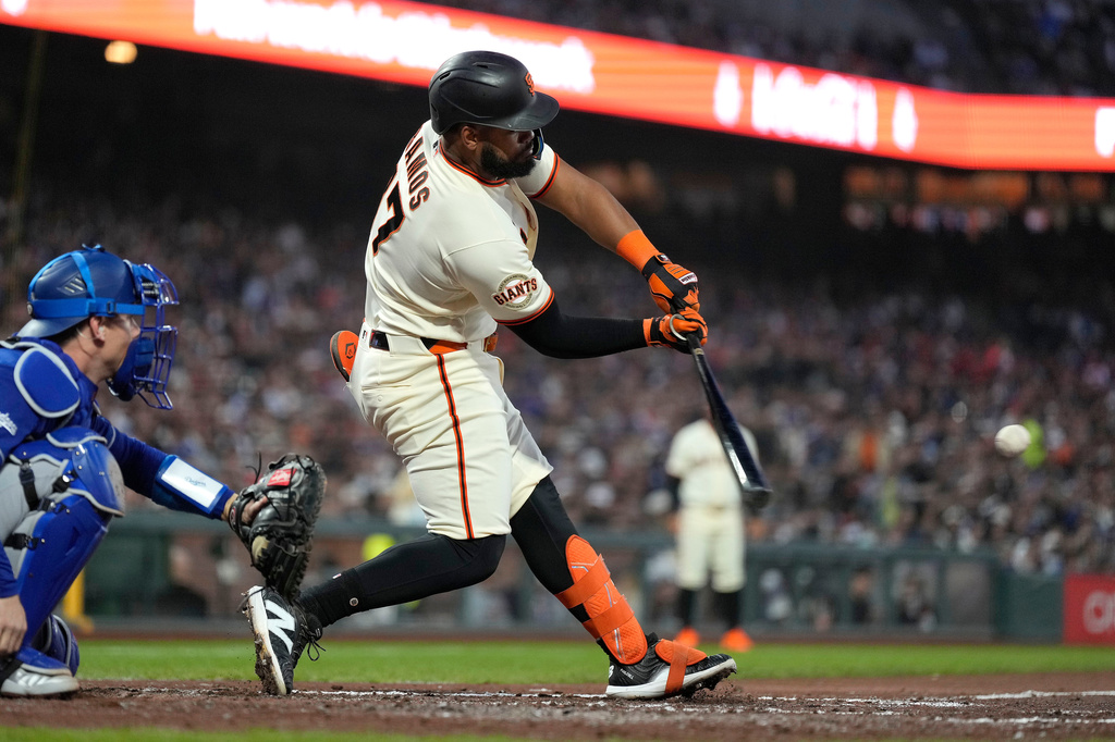San Francisco Giants' Heliot Ramos hits a single against the Los Angeles Dodgers during the fifth inning of a baseball game Wednesday, April 22, 2026, in San Francisco. (AP Photo/Tony Avelar)
