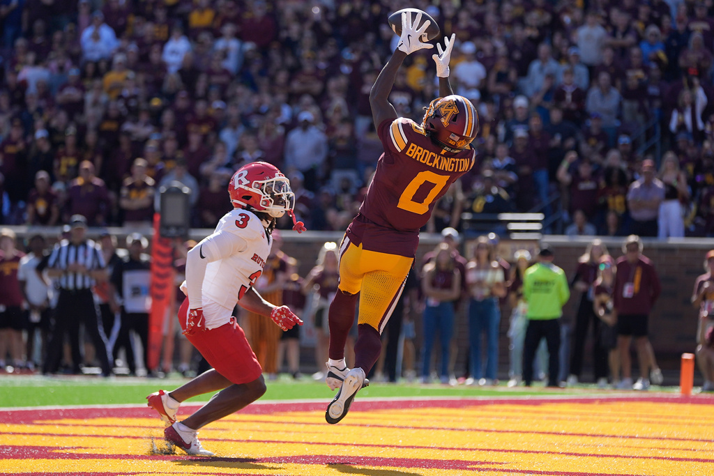 Minnesota wide receiver Le'Meke Brockington (0) catches an 8-yard touchdown pass over Rutgers defensive back Bo Mascoe (3) during the first half of an NCAA college football game Saturday, Sept. 27, 2025, in Minneapolis. (AP Photo/Abbie Parr)