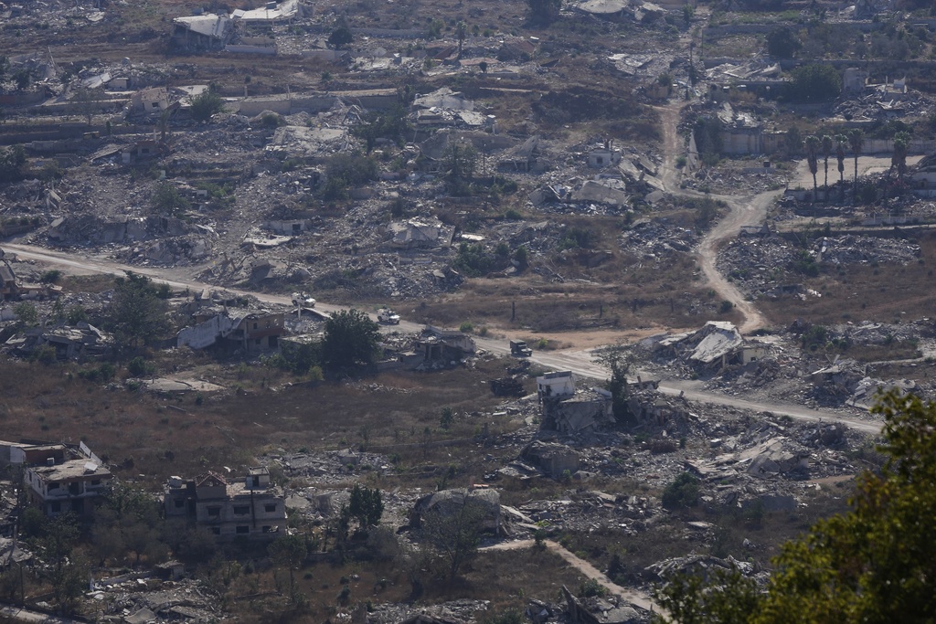 U.N. vehicles drive through destruction near the Lebanese-Israeli border in the village of Kfra Kila, southern Lebanon, Wednesday, Aug. 20, 2025. (AP Photo/Hussein Malla)