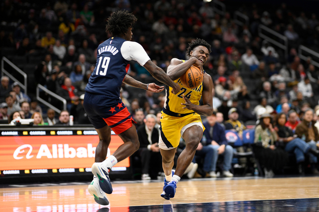 Washington Wizards guard Kadary Richmond (19) battles for the ball against Indiana Pacers guard Kobe Brown (24) during the first half of an NBA basketball game, Thursday, Feb. 19, 2026, in Washington. (AP Photo/Nick Wass)