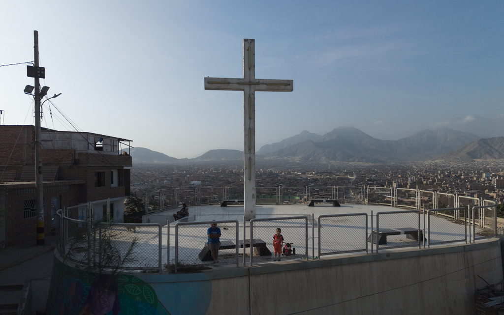 Residents stand at the Mirador overlooking the El Porvenir neighborhood in Trujillo, Peru, Sunday, May 24, 2026. (AP Photo/Rodrigo Abd)