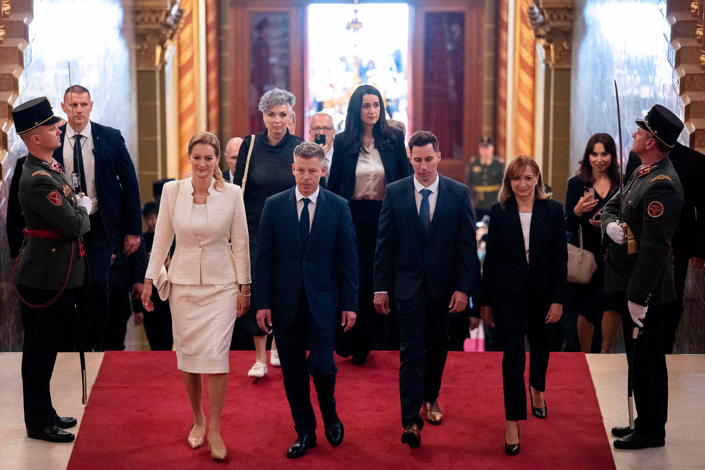 Hungarian Prime Minister-elect Peter Magyar, center, arrives with fellow lawmakers at the Parliament building in Budapest, Hungary, Saturday, May 9, 2026. (AP Photo/Denes Erdos)
