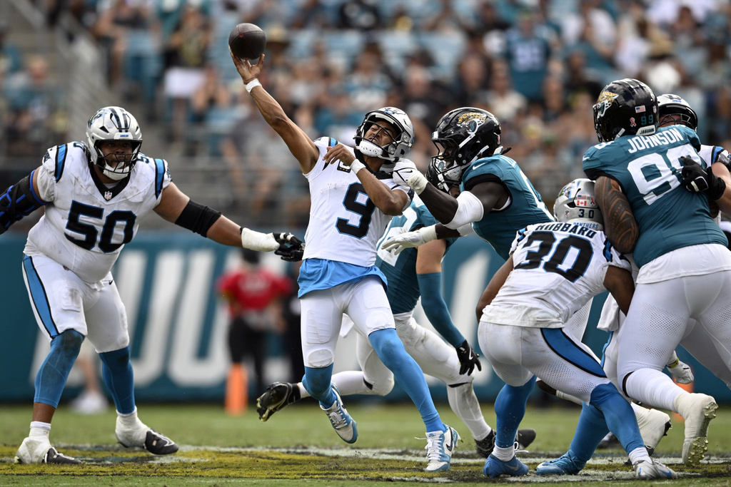 Carolina Panthers quarterback Bryce Young (9) throws against Jacksonville Jaguars linebacker Devin Lloyd (0) during the second half of an NFL football game, Sunday, Sept. 7, 2025, in Jacksonville, Fla. (AP Photo/Phelan M. Ebenhack)