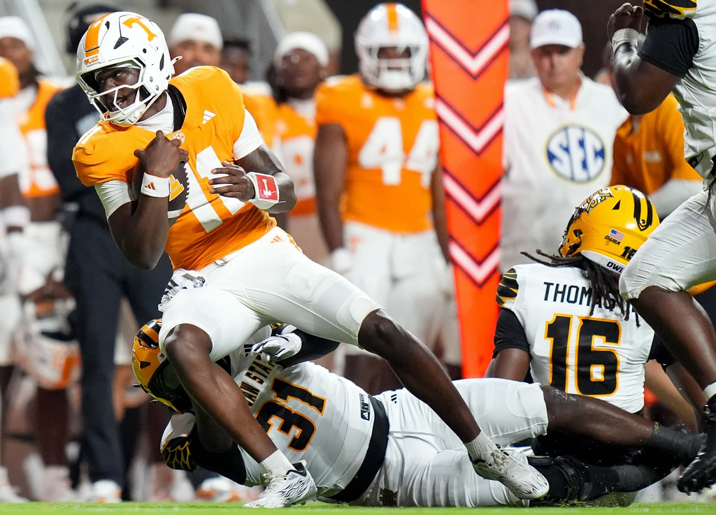 Tennessee quarterback Faizon Brandon (11) tries to evade Kennesaw State linebacker Kai Russell (31) during the first half of an NCAA college football game Saturday, Sept. 19, 2026, in Knoxville, Tenn. (AP Photo/Camden Hall)